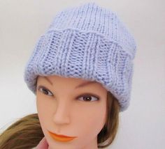 a mannequin head wearing a blue knitted hat