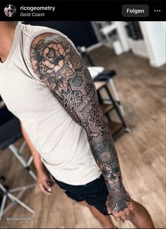 a man with a flower tattoo on his arm