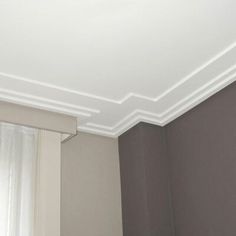 an empty room with white trim on the ceiling