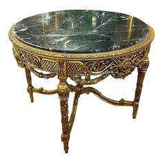 an ornately decorated table with marble top