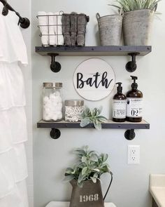 a bathroom with two shelves above the toilet and some plants on the shelf below it