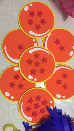 the scissors are laying next to some cut out paper circles with stars and shapes on them