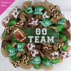 a football wreath with the word go team on it and some decorations hanging from the front door