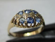 Quality early Edwardian 18ct solid gold diamond and sapphire gemstone ring. The head of the ring is marquise shaped, size 10.0mm{North to South} x 12.0mm{East to West} and is encrusted with rows of light blue sapphire gemstones and diamond gemstone chips. All of the gemstones are in top condition and exposed to the ring's reverse side to allow the light to shine through to make them glow, also for easy cleaning access. The shank is straight and displays a full striking Birmingham 18ct gold assay hallmark for the year 1903 on its inside circumference. Size 'R-S'{UK}, 9.25{US}. Weighs 3.1 grams. Superb condition throughout with genuine precious gemstones, no repairs and full authentication for its year of manufacture --- a pretty Edwardian example. Light Blue Sapphire, Sapphire Gemstone, Precious Gemstones, Diamond Gemstone, Gemstone Ring, Rings Statement, Birmingham, Blue Sapphire, Easy Cleaning