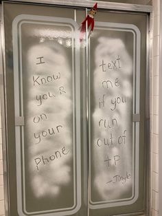 two glass doors with writing written on them