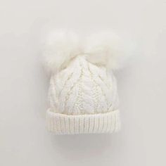 This sweet cable knit hat in a creamy white color is topped with 2 dyed-to-match furry pom poms. Adorable for the holidays and makes a great photo prop. • 100% Acrylic• Cold handwash• Hand knit in China Cute Winter Hats, Cable Knit Hat, Newborn Hat, Recycled Yarn, Faux Fur Pom Pom, Knit Beanie Hat, Cute Hats, Winter Fun, Pom Pom Hat