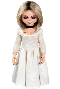 a doll dressed in white with black eyes