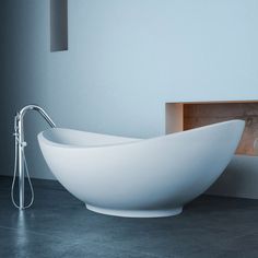 a large white bowl sink sitting on top of a counter next to a faucet