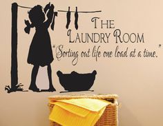 a laundry room wall decal with a girl and cat hanging out to dry her clothes