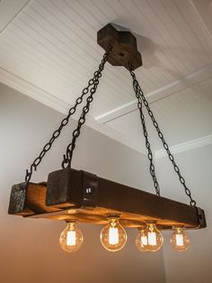 the light fixture is made from wood and has five bulbs hanging from it's chain