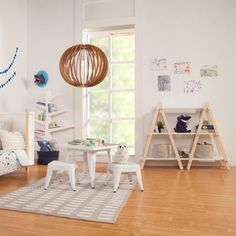 a child's room with white furniture and wooden flooring