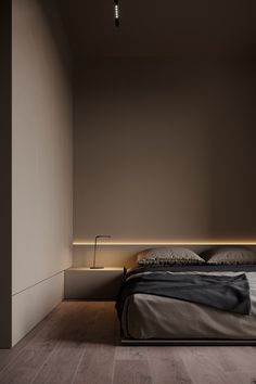 a bed sitting in the middle of a bedroom next to a wall