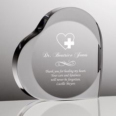 a heart shaped glass award with a white cross on it