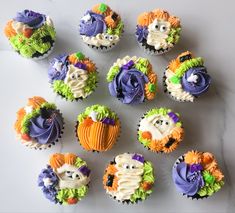 cupcakes decorated with icing and decorations on top of a white countertop