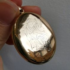 A fine, antique, solid 15ct gold oval locket pendant, with an attractive, raised wreath motif to the front, and a hand-engraved monogram to the reverse, spelling out the initials "RTSS". The locket opens to reveal space inside for two photographs.Circa 1890.Unmarked, tested as 15ct gold.The pendant measures approximately 46 x 28mm (including the halter).The approximate weight is 15.9 grams.Please note that the antique box and chain pictured are for display purposes only. Thank you.CONDITION: In Gold Wreath, Peacock Pendant, Oval Locket, Antique Boxes, Gold Engraving, Amethyst Pendant, Diamond Cluster Ring, Favorite Rings, Diamond Cluster