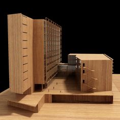 an architectural model of a building made out of wood