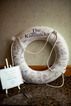 a life preserver with writing on it next to a sign that says the kimnicks