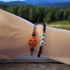 Handcrafted beaded bracelets.  🎃Jack 0 Lantern and the other has the word "BOO"👻 This is for a set of 2 stretch bracelets made with glass beads and acrylic letter beads.  Wear them alone or stack them with other bracelets.  A perfect addition to any wardrobe. Great gift idea!  If you are buying it as a gift the standard size is 7".  How to measure for a bracelet... Wrap a measuring tape around your wrist at the point where you want to wear the bracelet. If you don't have a flexable measuring tape, use a piece of string, or strip of paper, mark the length, and measure it with a ruler.  Now make sure you add 1/2" to your measurement. Women's Extra Small: 6.5 inches Women's Small: 6.75 inches Women's Standard: 7 Inches Women's Medium: 7.25 Inches Women's Large: 7.5 Inches 🎃Thank you for vi Halloween Novelty Beaded Bracelets With Round Beads, Halloween Beaded Bracelets With Letter Beads, Halloween Novelty Bracelet With Round Beads, Halloween Bracelets With Letter Beads And Round Shape, Halloween Letter Beads Bracelet With Round Beads, Word Bracelets, Halloween Words, Halloween Beads, Word Bracelet