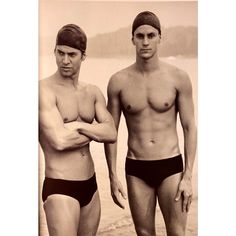 two men standing next to each other in bathing suits