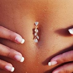 a woman's stomach with white nails on it