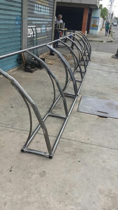 a row of metal bars sitting on the side of a building