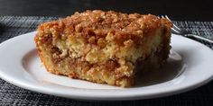 a piece of coffee cake sitting on top of a white plate