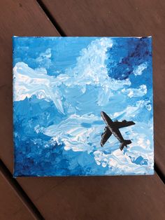 a painting of an airplane flying in the sky with clouds and blue skies behind it