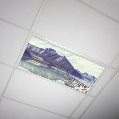 the ceiling is painted white with mountains in the background