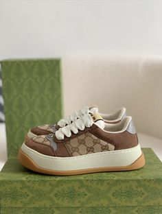 Embrace vintage-inspired style with these Double G-inspired sneakers. The beige and brown color palette and the signature Double G monogram create a sophisticated and timeless look. The chunky sole and mixed material upper add a touch of retro athleticism, while the meticulous craftsmanship ensures lasting quality and comfort. Elevate your everyday style with these statement-making sneakers. Luxury Classic High-top Custom Sneakers, Gucci Vintage Sneakers, Luxury Custom Beige Sneakers With Gum Sole, Luxury Lace-up Custom New Balance Sneakers, G Monogram, Fall Winter Jacket, Brown Color Palette, Gucci Sneakers, Loafer Sneakers