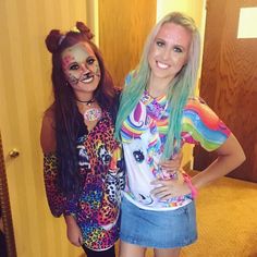 two young women with painted faces posing for a photo in front of a door and carpeted floor