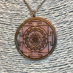 "Sri Yantra in 925 silver and rose mother of pearl backdrop. It's one of the most powerful symbol in sacred geometry, belonging both to Induism and Buddhism traditions. It has a complex structure made of nine interlocking triangles: four of them, looking upside, show male power and Shiva, five of them, looking down side, express a female Energy and her Goddes Shakti. These 43 triangles represent the cosmos and the human body, they surround a point known as bindu, source of Creation. The jewel he Spiritual Medallion Necklaces Stamped 925, Spiritual Pink Jewelry For Festivals, Spiritual 925 Stamped Medallion Necklaces, Spiritual Medallion Necklace Stamped 925, Pink Spiritual Jewelry For Festivals, Pink Engraved Round Necklace, Luxury Spiritual Pendant Jewelry, Hand-strung Spiritual Silver Necklace, Pink Spiritual Round Pendant Jewelry