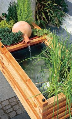 a wooden planter filled with water and plants