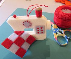 a table topped with yarn and scissors on top of it