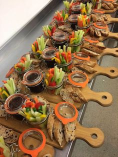 a long table with many different types of food on it, including crackers and dips