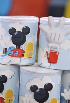 mickey mouse cups are stacked on top of each other in the shape of buckets