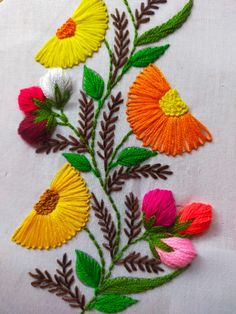 embroidered flowers and leaves on white fabric