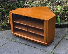 a wooden cabinet sitting on top of a sidewalk