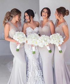 the bridesmaids are holding their bouquets in front of each other and laughing