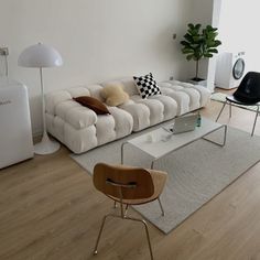 a living room filled with furniture and a white rug