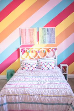 a bedroom with colorful striped walls and bed