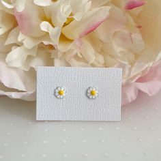 Dainty and delicate set of mini daisy stud earrings. Metal : 925 Sterling Silver. ( 925 stamped ) Weight : 0,45g. Measurements : 9mm x 7mm. (aprox) Material : Enamel. These delicate stud earrings are handcrafted from 925 sterling silver, that doesn't tarnish their little ears also hypoallergenic and nickel free. PACKING: All jewelry is package already to be gifted. Just let me know if the gift is for a birthday, I will add some fun birthday confetti! Also you have the opportunity to add a person Dainty Hypoallergenic Flower Earrings, Dainty White Sterling Silver Flower Earrings, Dainty Hypoallergenic Flower Earrings For Mother's Day, Dainty Daisy Sterling Silver Jewelry, Nickel-free Daisy Earrings For Gifts, Nickel-free Daisy Flower Earrings Gift, Cute Silver Flower Charm Earrings, Tiny Sterling Silver Flower Earrings As Gift, Cute Silver Flower Shaped Earrings