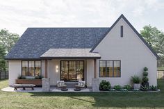 a small white house sitting on top of a lush green field