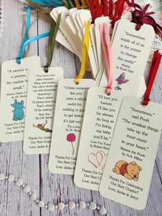 four bookmarks with winnie the pooh sayings on them next to some beads