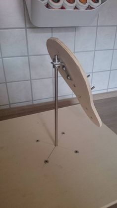 a wooden table topped with donuts on top of a white tiled wall next to a cupcake holder