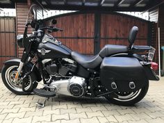 a black motorcycle parked in front of a garage