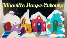 three cardboard houses with snow on them and the words whoville house cut outs in front of them