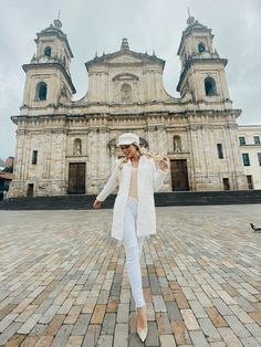 a woman standing in front of a large building