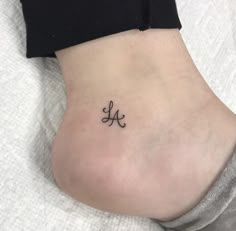 a woman's foot with a small tattoo on the side of her leg,