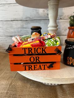 a trick or treat box with candy and candies in it sitting on a table