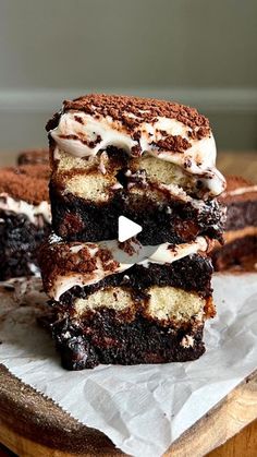 three pieces of cake sitting on top of a wooden cutting board